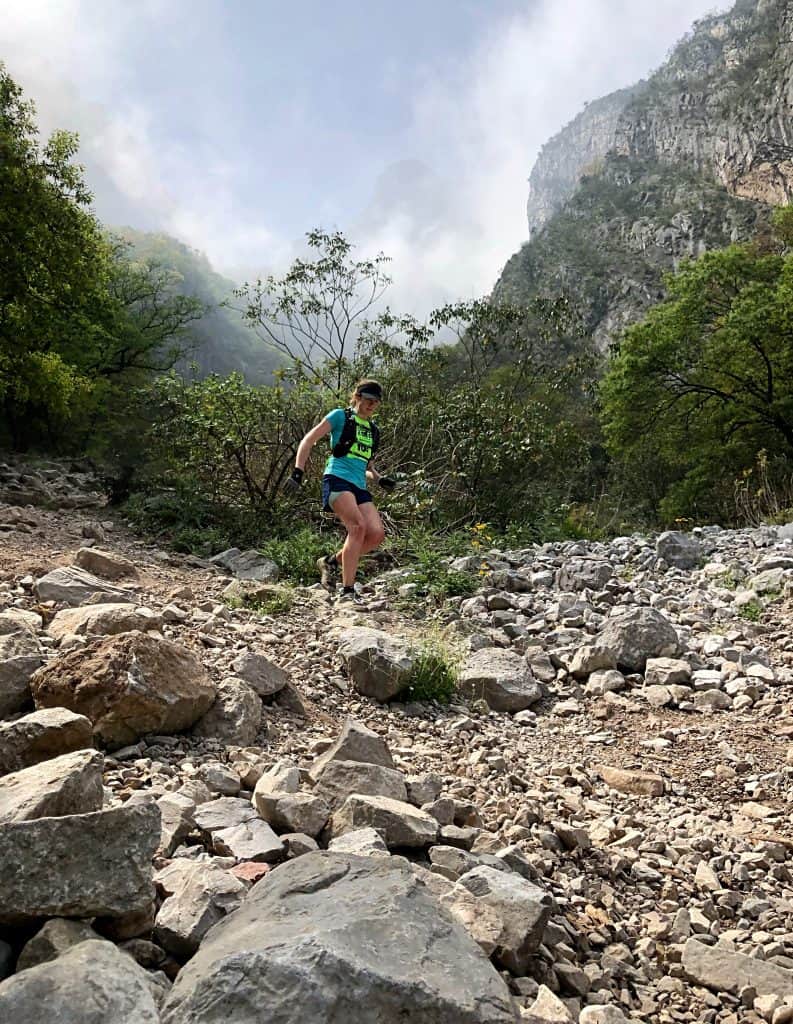 Trail runner descending the rocky slopes of Mitras as part of the annual Trilogía de las Montañas event.